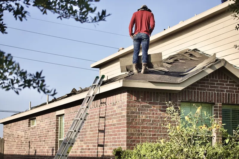 Professional roofer working on a residential roof in Old Saybrook